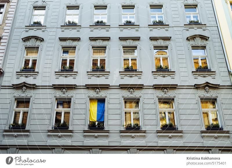 Prague, Czech - February 2023. Apartment building facade with ukrainian flag alley antique apartment apartments architecture balcony beautiful blue bohemia