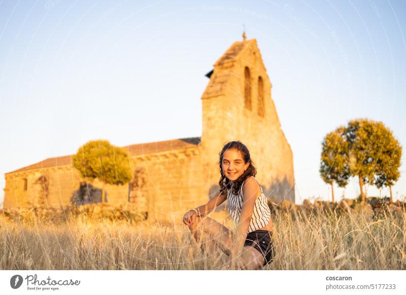 Country girl on a meadow with a church in the background beautiful portrait building child childhood children church building country country style countryside