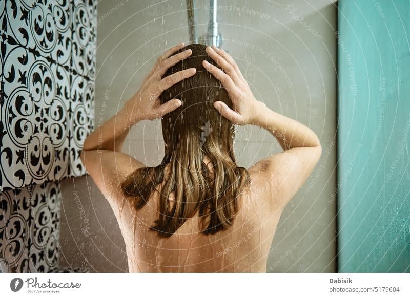 Back view of woman taking a shower in bathroom take back hair hygiene body head clean cabin shampoo washing candid care beauty caucasian enjoy female fresh girl