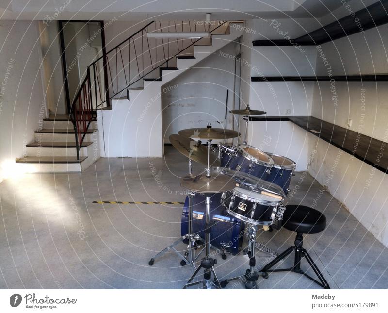 Classical drum set in an empty music store with empty shelves and staircase in the main street of Oerlinghausen near Bielefeld on the Hermannsweg in the Teutoburg Forest in East Westphalia-Lippe