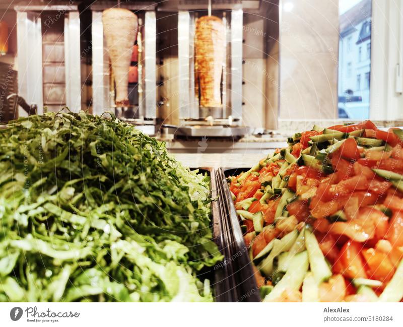 Green salad and tomato cucumber salad in front of two kebab skewers in a snack bar Snack bar Eating Meat Veal Chicken meat Poultry eat out Outward Nutrition