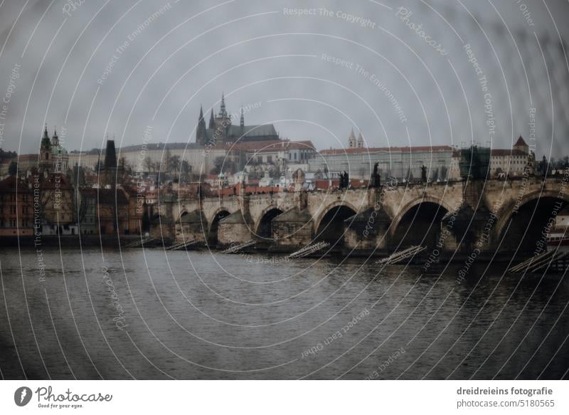 Charles Bridge in Prague through a fence Prague Castle in the background Town Europe Czech Republic City trip Travel photography River The Moldau Card cityscape