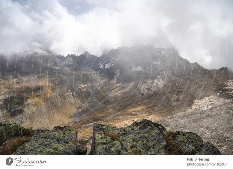 Mountain peak in alps under cloud cover with rocks in foreground Clouds Rock Alps Peak Landscape Nature Snowcapped peak Deserted Colour photo Environment