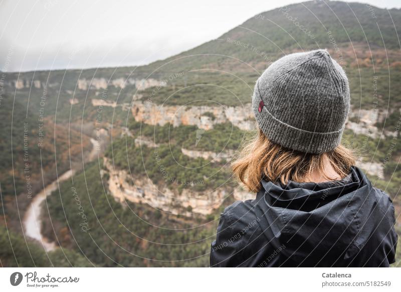 Young woman looks at the Ebro Nature Environment Landscape Canyon Sky Rock trees Water River ebro persons Human being Head Cap Hiking Day daylight Gray Green