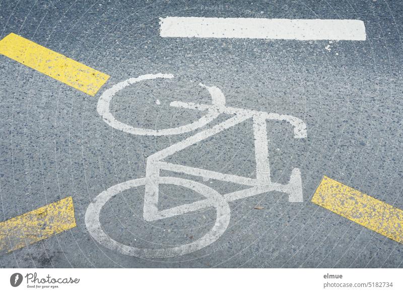 Pictogram of a bicycle with yellow marking stripes on an asphalt road / bike path / bike ride cycle path Bicycle ride a bicycle Street Road marking Asphalt road