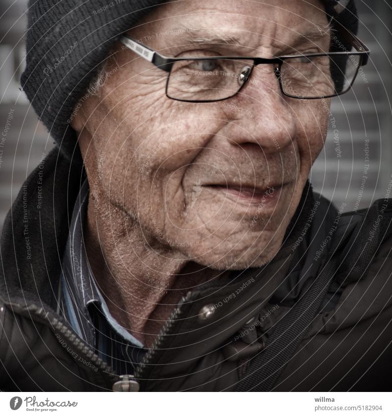 Senior, overly blurred Senior citizen portrait Man Eyeglasses View to the side grin Observe critical Cap Anorak Good mood age wrinkle