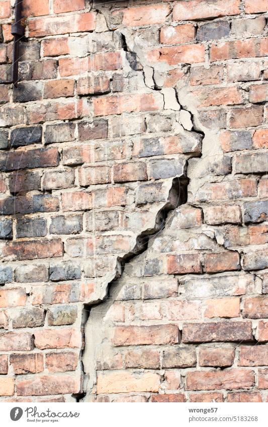Large crack in a brick wall Brick wall Crack & Rip & Tear Old offset steadfastness in danger of collapsing Danger of collapse Broken Wall (building)