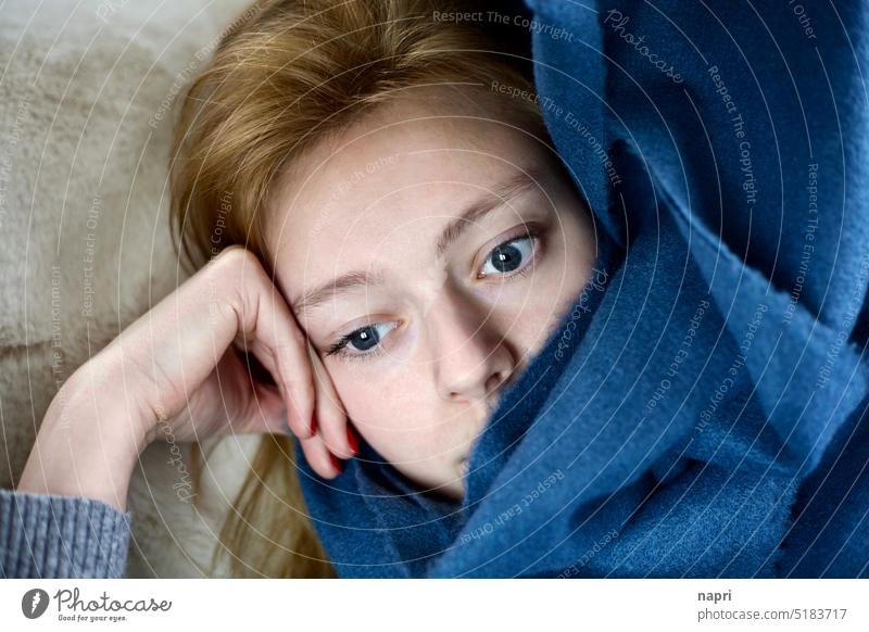 Winter blues | Young woman lying snuggled up with a fluffy blanket staring depressed in front of her dejected Meditative sad unhappy tired on one's own Sadness