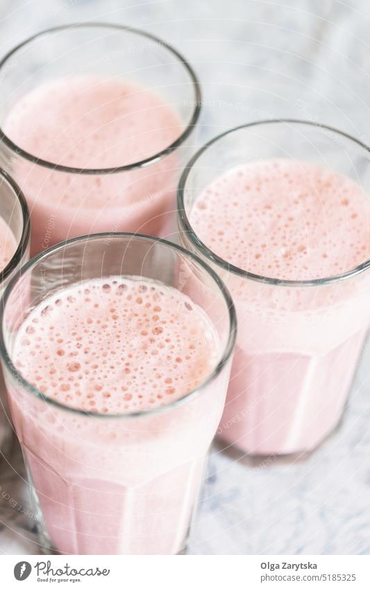 Top view on glasses of strawberry milkshake or smoothie on table. healthy refresh drink pink top view red mint cold summer white close up selective focus detox