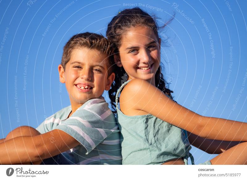 Two relaxed kids against blue sky at summer beautiful boy child children closeup cute day face family freedom friends fun girl handsome happy lifestyle little