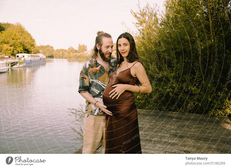 photoshoot of future parents showing a pregnant woman and a father by the river family people Beautiful mother young motherhood belly Baby Baby bump