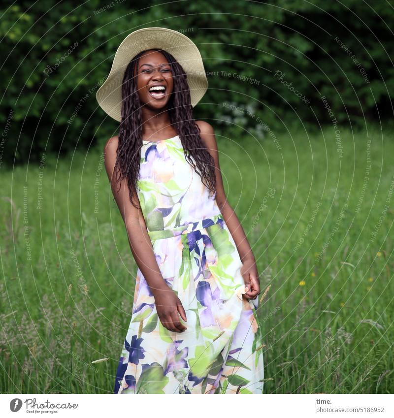 laughing woman with straw hat in a meadow Feminine Woman Park Meadow Dress Hat Long-haired Dark-haired Laughter Stand Joy Happy pretty Happiness Free