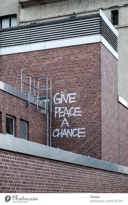GiVE PEACE A CHANCE Peace peace Give peace a chance Wall (building) Wall (barrier) Facade Graffiti clinker embassy War Hope Peace Wish Sign
