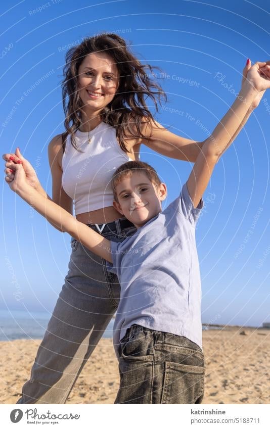 Happy Mother and son playing on beach in a sunny day at sundet. Family together sea sunset outdoor Toddler kid boy family Mom fun smile sand spring summer