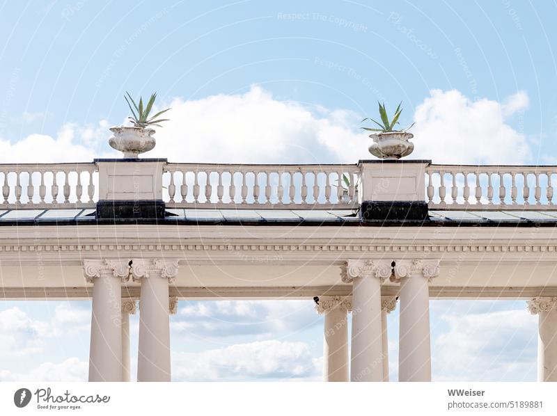 When you lift your eyes you see a balustrade and clouds in the sky Summery Lock columns Sky Clouds Cheerful Flower vases Weathered Above Tall items decoration