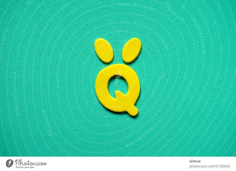 yellow stylized Easter bunny in the shape of Q with egg-shaped ears on turquoise background / Easter Easter Bunny variegated Egg Easter decoration Hare ears