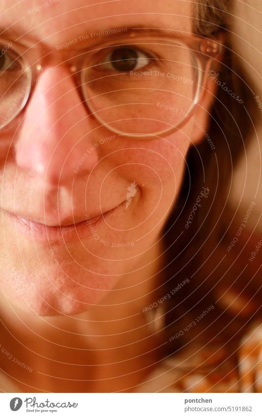 part of face of soft smiling woman with glasses Woman kind Face Eyeglasses Smiling Smooth warm colors Brunette portrait Feminine Charming contented eye contact