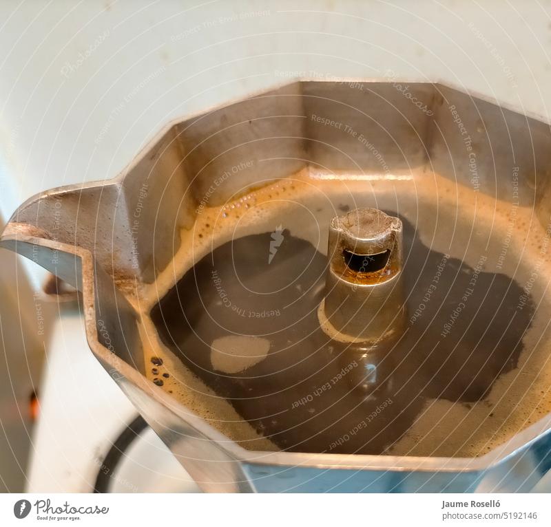 close-up of the top of an Italian coffee pot with the lid open with the freshly brewed coffee shadow enjoyment fine grey lifestyles luxury manufacturing