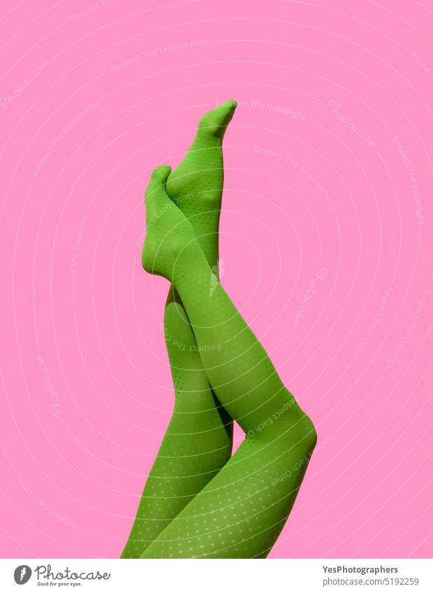 Woman legs in green tights isolated on a pink background 40s athletic beautiful beauty body bright care clothes color concept copy space creative cut out