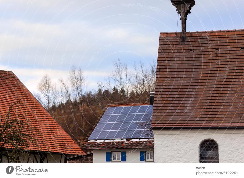 Photovoltaic system on the roof of a farmhouse in Gaishaus near Ravensburg in Baden Würtemberg on a cloudy day in winter CO² neutrality Electromobility building