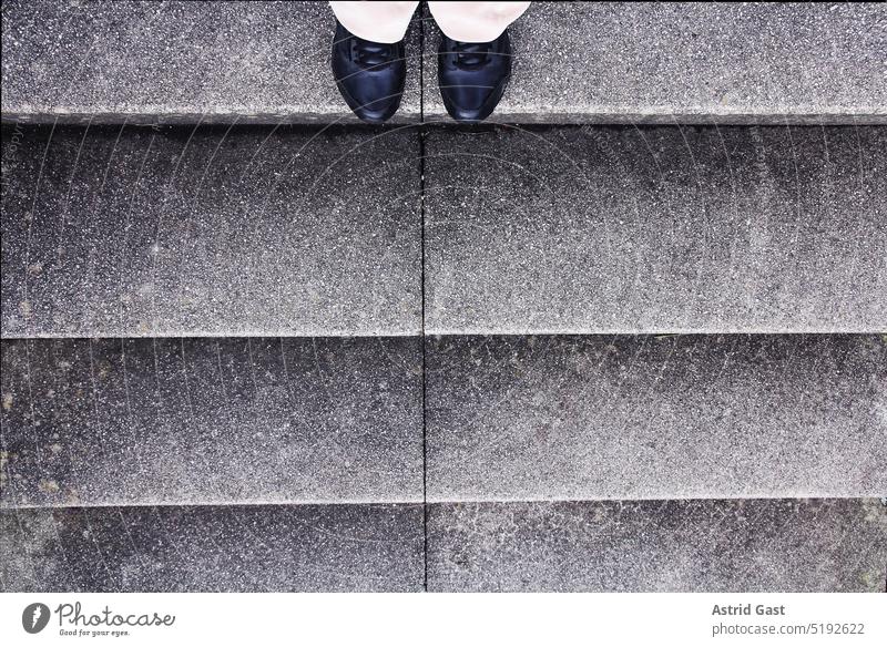A woman stands indecisively at the beginning of a staircase Woman feet Legs Stairs stagger Stage stair treads Fear Insecure insecurity Footwear Going fake dizzy