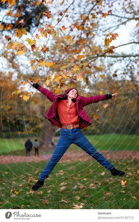 She girl jumps in the autumn nature foliage. caucasian yellow fun portrait person pretty woman lifestyle fall outdoor happy park autumn colors casual clothing