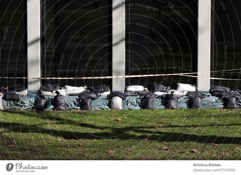 sandbags as flood protection in front of large windows Sandbags Stack Protection building protection Building Window House (Residential Structure) Packing film