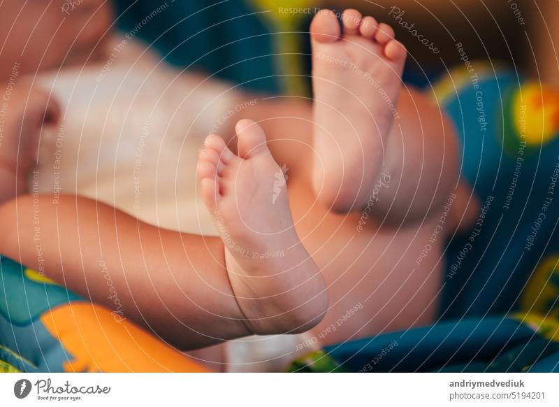 the feet of a small child. Newborn's little fingers. cute little baby feet foot newborn mother beautiful white family closeup love care hand healthy human life