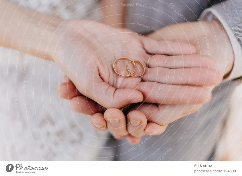 man and woman with wedding ring.Young married couple holding hands,  13873359 Stock Photo at Vecteezy