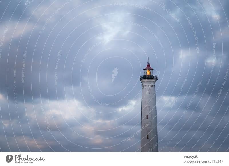 Lighthouse with beacon Beacon Tower Safety Orientation Disorientated Reference point Orientation marks Guidance Clouds Sky cloudy blue hour one Deserted