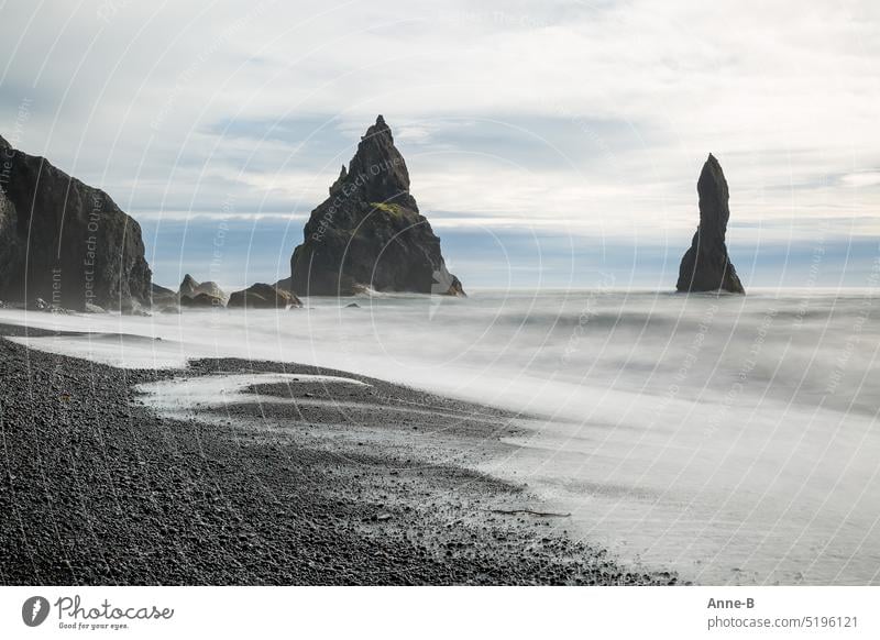 Soft waves on the rough and really very dangerous Reynisfjara beach in southern Iceland. soft water voyage black beach Basalt Rock stones Long exposure