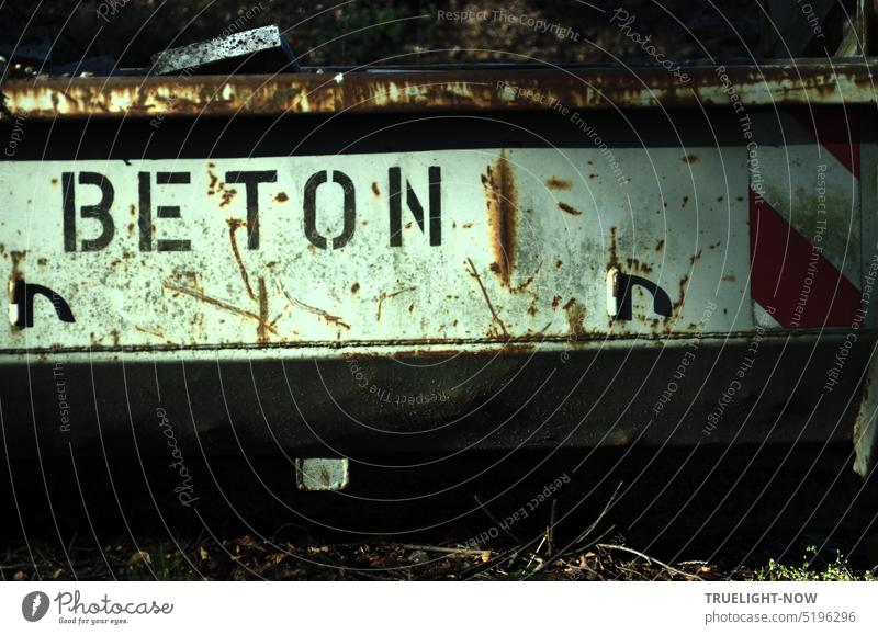 BETON is written on a sign on an old rusty construction waste container Concrete Signs and labeling Clue Orientation Recommendation Recycling Building rubble
