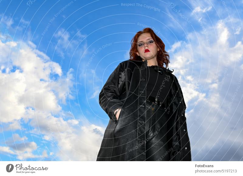 Young girl against a blue sky view portrait fashionably nature person young look Girl human being outside real coat clothes black woman test clearance
