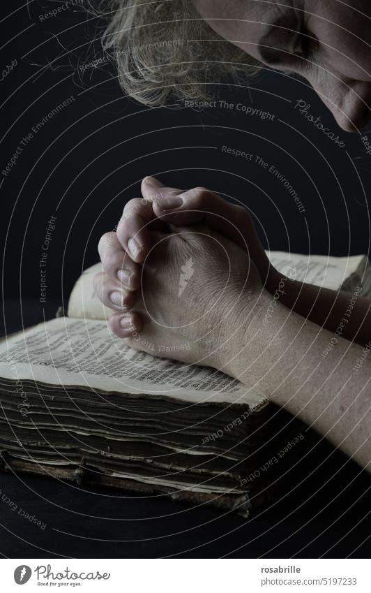 Woman praying with folded hands over antique bible Bible Belief Christianity Religion and faith Spirituality believe religion Prayer silent period Folded