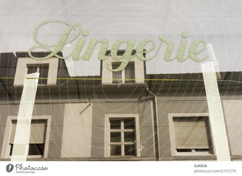 Lingerie shop window with reflection lingerie writing vintage Shop window houses Facades apartment buildings Window Roof Building Glass Reflection Old