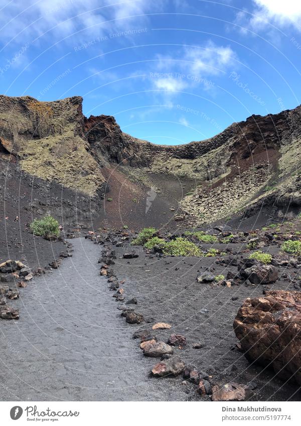 Dormant volcano crater inside. Travel in Lanzarote, Spain. Black soil of volcanic island. view beautiful outdoor travel heat natural traveler lava water light
