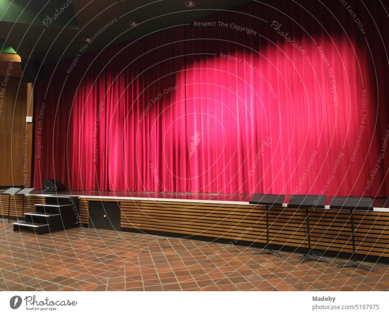 Stage with red theater curtain in the auditorium of a high school in Oerlinghausen near Bielefeld on the Hermannsweg in the Teutoburg Forest in East Westphalia-Lippe
