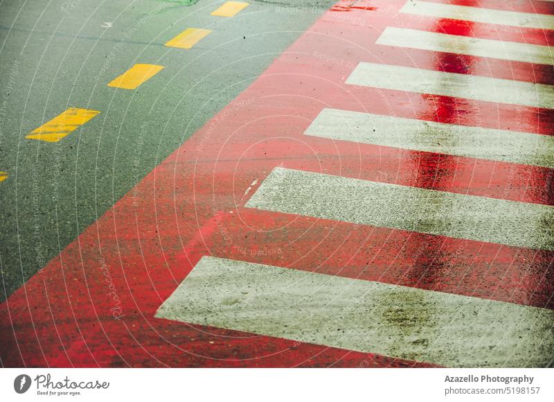 Zebra crossing sign on a wet road. Asphalt road with zebra crossing. rain minimalism guidance transportation destination concept pointing perspective direction