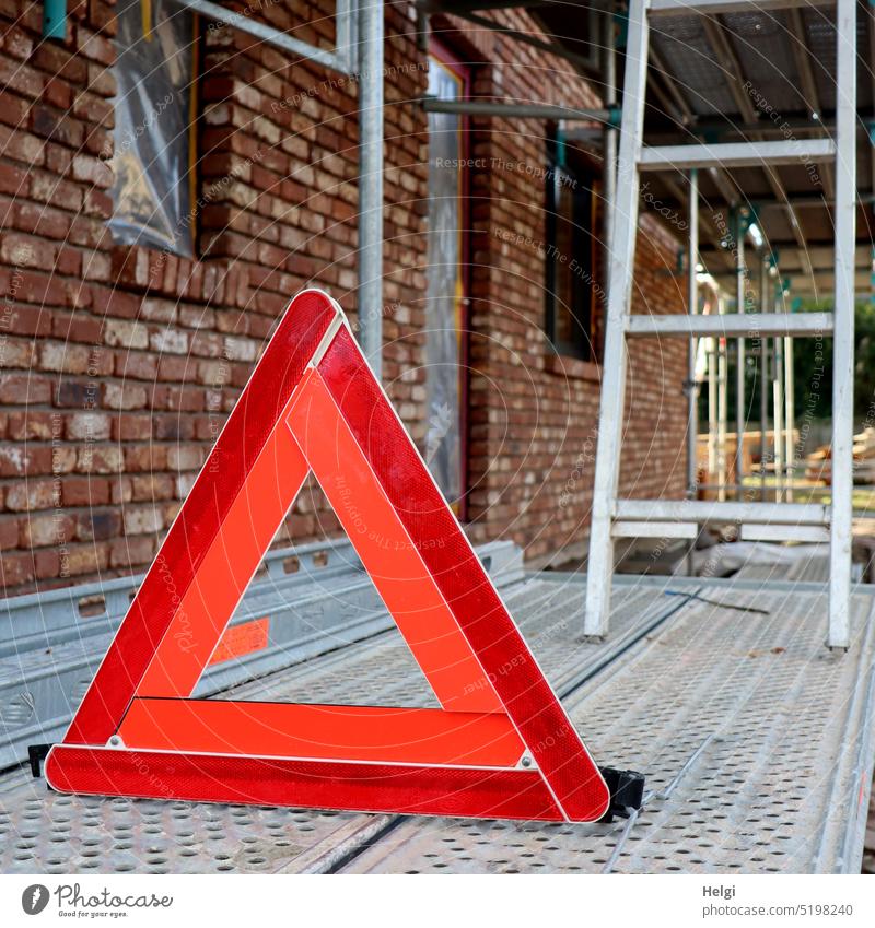 Attention! Danger! - red warning triangle stands on a scaffold at a construction site peril Warn Triangle Scaffolding Construction site danger spot esteem watch