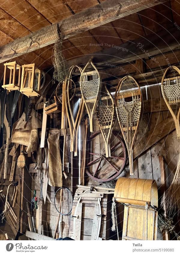 1800’s farm workshop displaying snowshoes, toboggans, and other wooden items Historical wagon wheel vintage Old