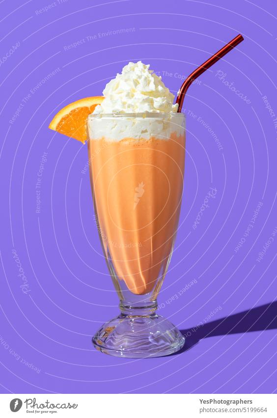 Orange milkshake glass minimalist on a purple background american beverage bright cocktail cold color copy space cream cuisine cup cut out dairy delicious