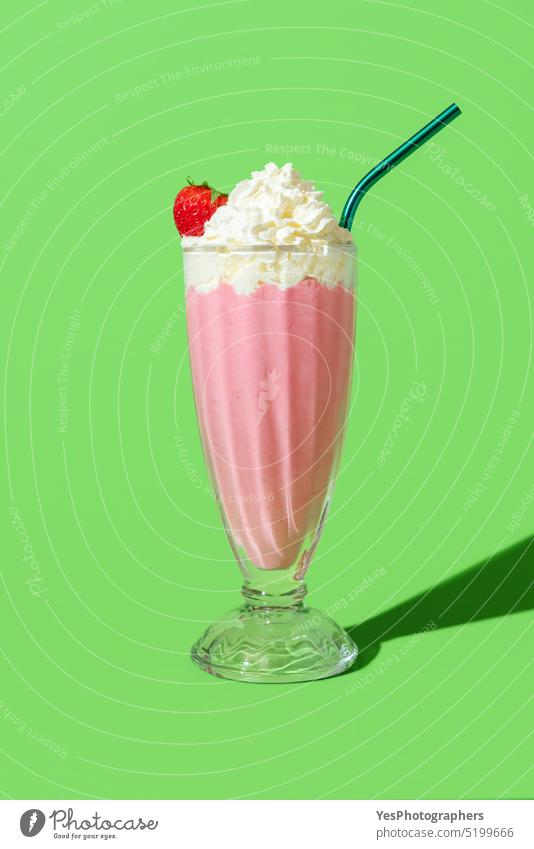 Strawberry milkshake with whipped cream, minimalist on a green background american beverage bright cocktail cold color copy space cuisine cup cut out dairy