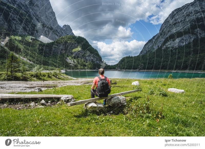 Man traveler on hiking trail to upper Gosau lake, Salzkammergut, Austria, Europe gosau europe man austria dachstein trunk gosausee happy peak salzkammergut