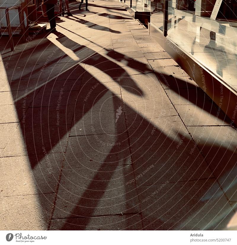 Light and shadow on the sidewalk in front of the storefront Footpath off Shadow Shopping line Shops Sidewalk Stone slab persons Visual spectacle Shadow play