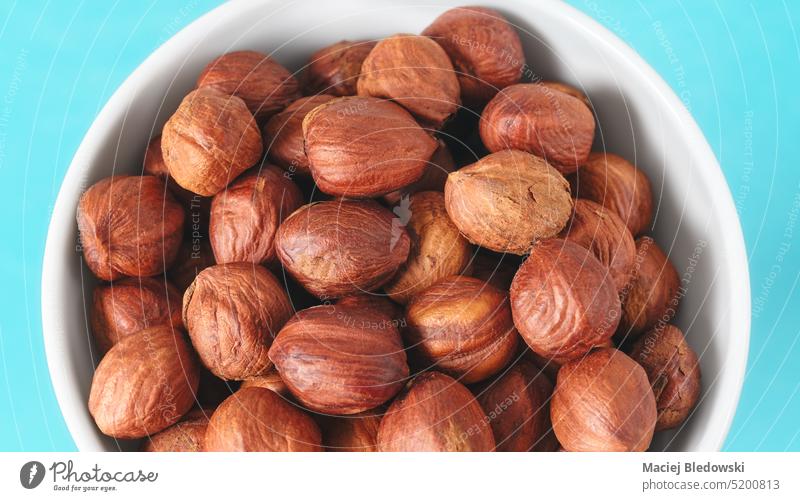 Close up picture of organic hazelnuts in a bowl, selective focus. snack superfood healthy ingredient close up nutrition kernel natural tasty diet antioxidant