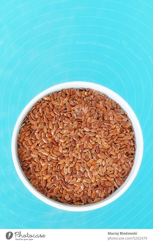 Close up picture of organic flax seeds in a bowl, selective focus. food linseed snack fat omega 3 fatty acids superfood healthy ingredient close up nutrition