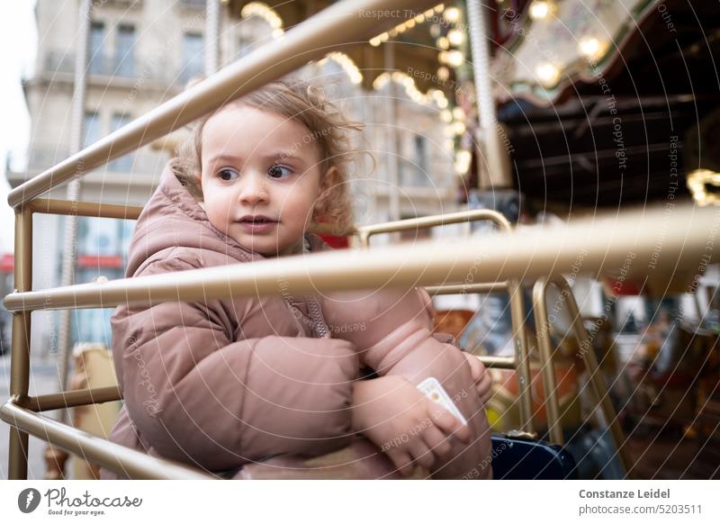 Toddler looking sideways in carousel Joie de vivre (Vitality) To enjoy people relaxed Rotation Infancy Movement Rotate Attraction Theme-park rides