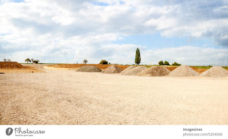 Construction site entrance. Piles of sand and gravel for construction. Limestone materials for the construction industry. Building site entrance Heap Sand