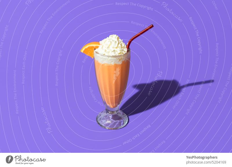 Orange milkshake isolated on a purple background. Milkshake glass in bright light above beverage cocktail cold color copy space cream cuisine cup cut out dairy