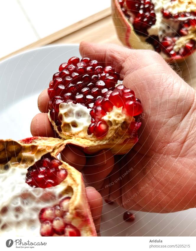 Man breaks apart a pomegranate Pomegranate Hand hands Fingers Close-up To hold on Healthy Eating salubriously Organic produce Food Fruit Fresh Red Vitamin-rich